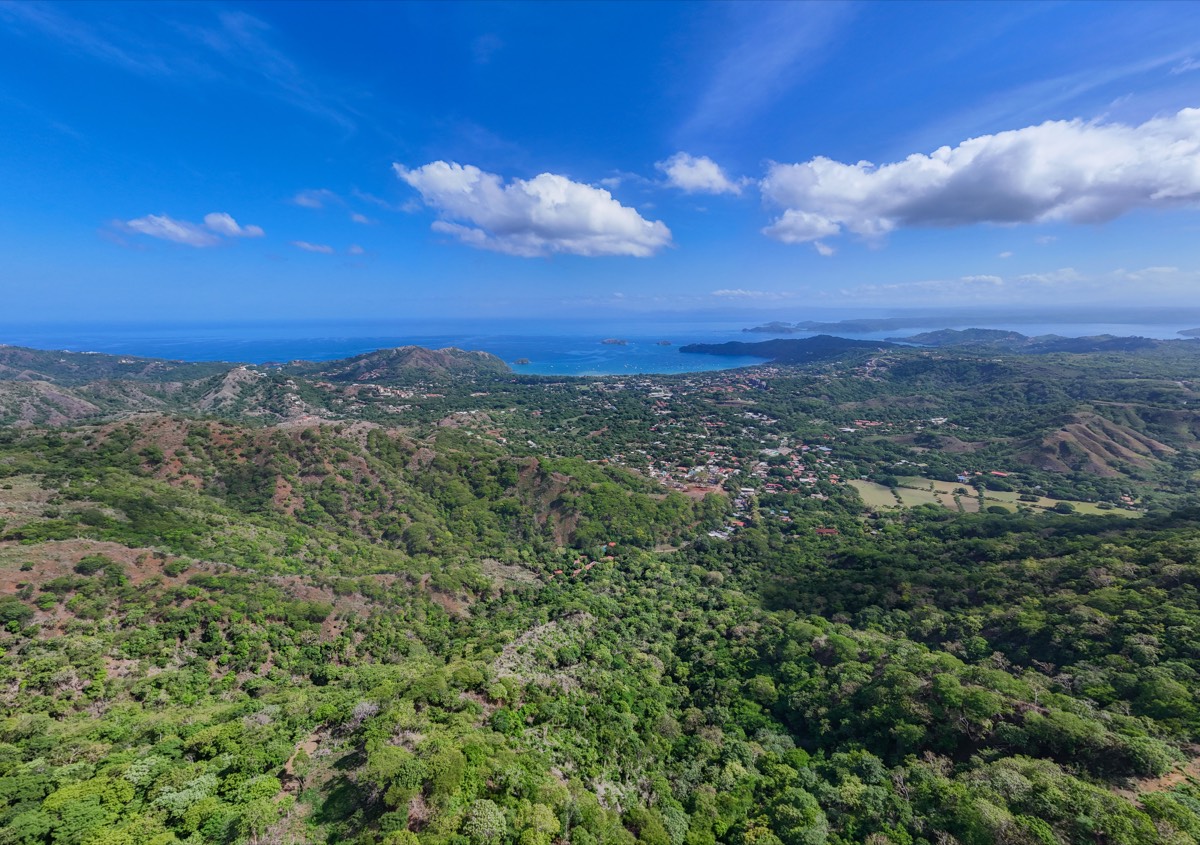 Guanacaste coastline with forested hills meeting the Pacific