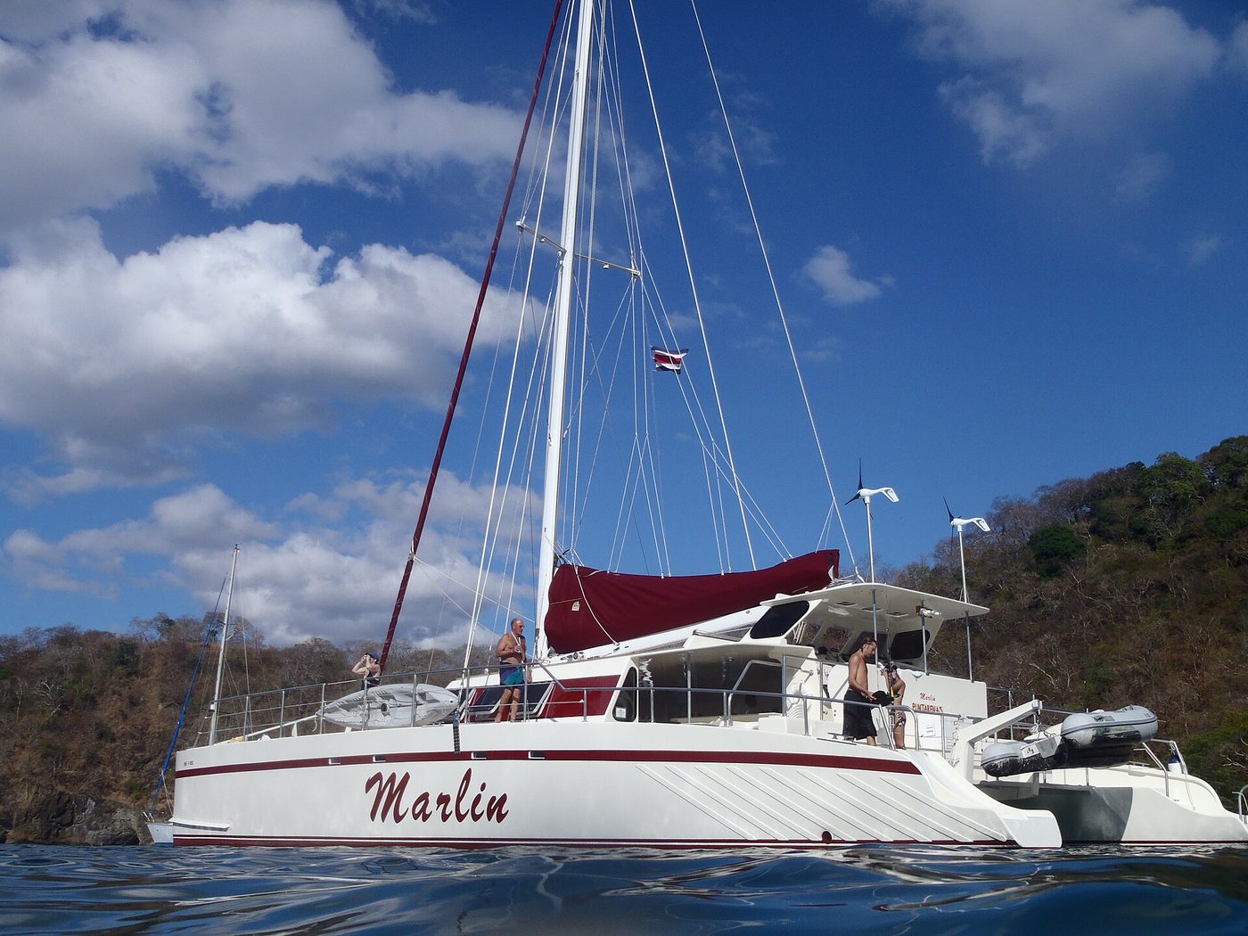 Sailing catamaran flying the Costa Rica flag anchored off the Guanacaste coast near Playas del Coco