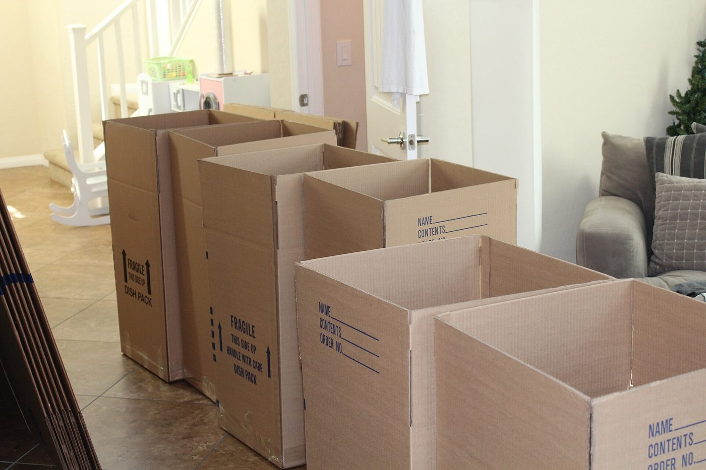 Empty cardboard moving boxes marked fragile lined up inside a home before a move