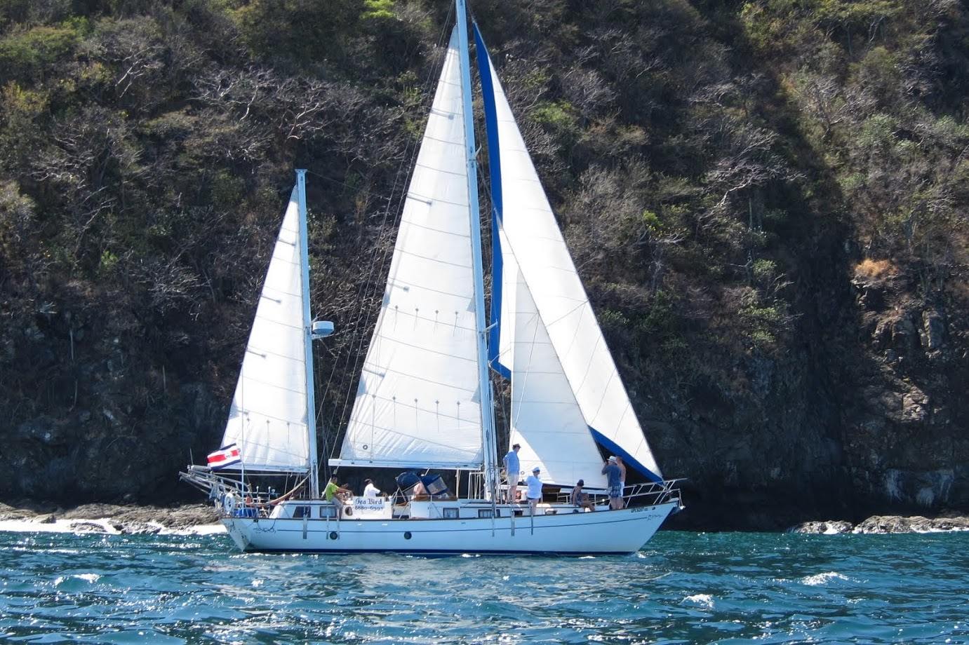 Sailboat flying the Costa Rican flag cruising Coco Bay near Playas del Coco
