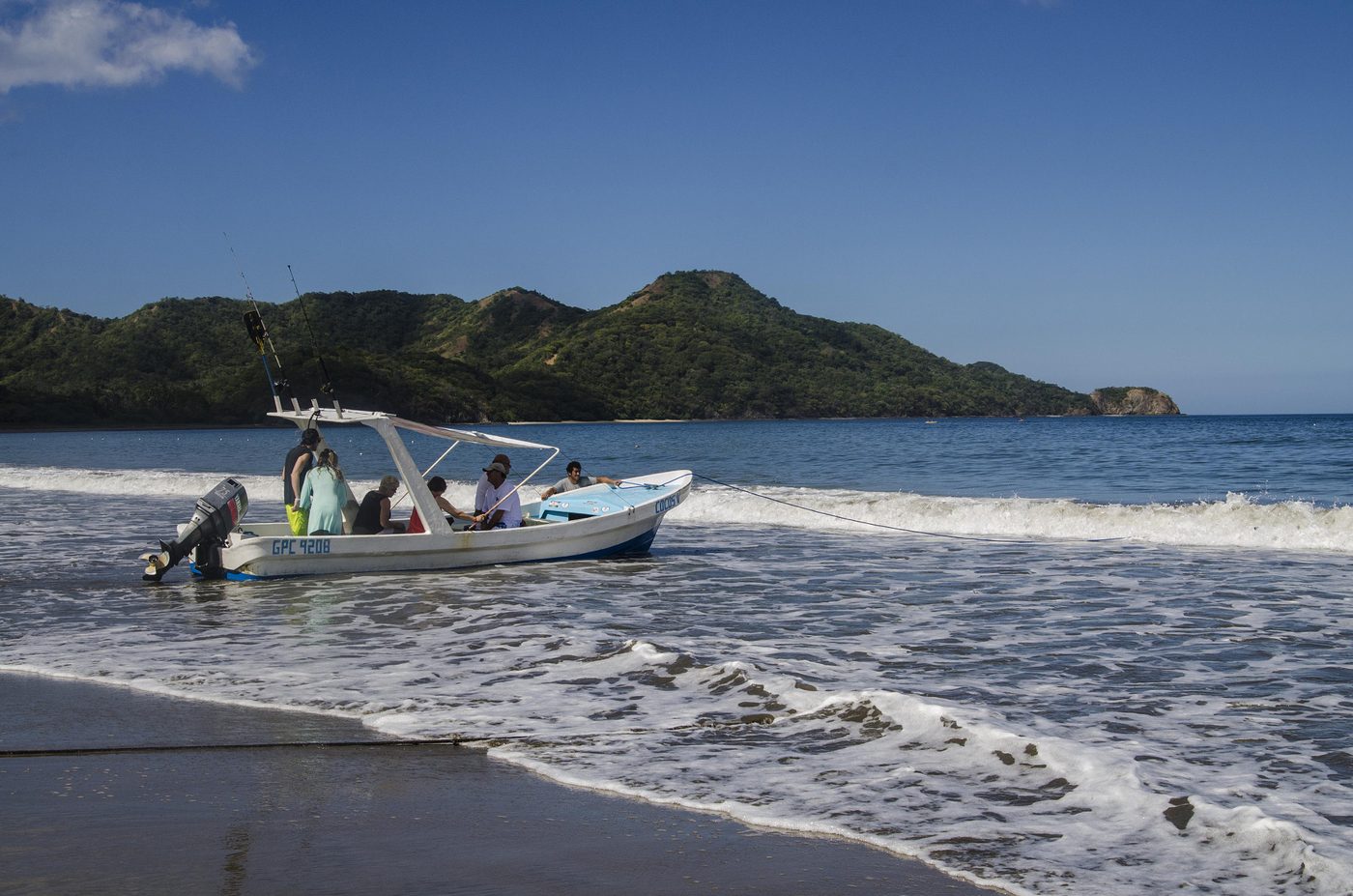 Tour boat collecting passengers in the surf at Playa Matapalo, Guanacaste