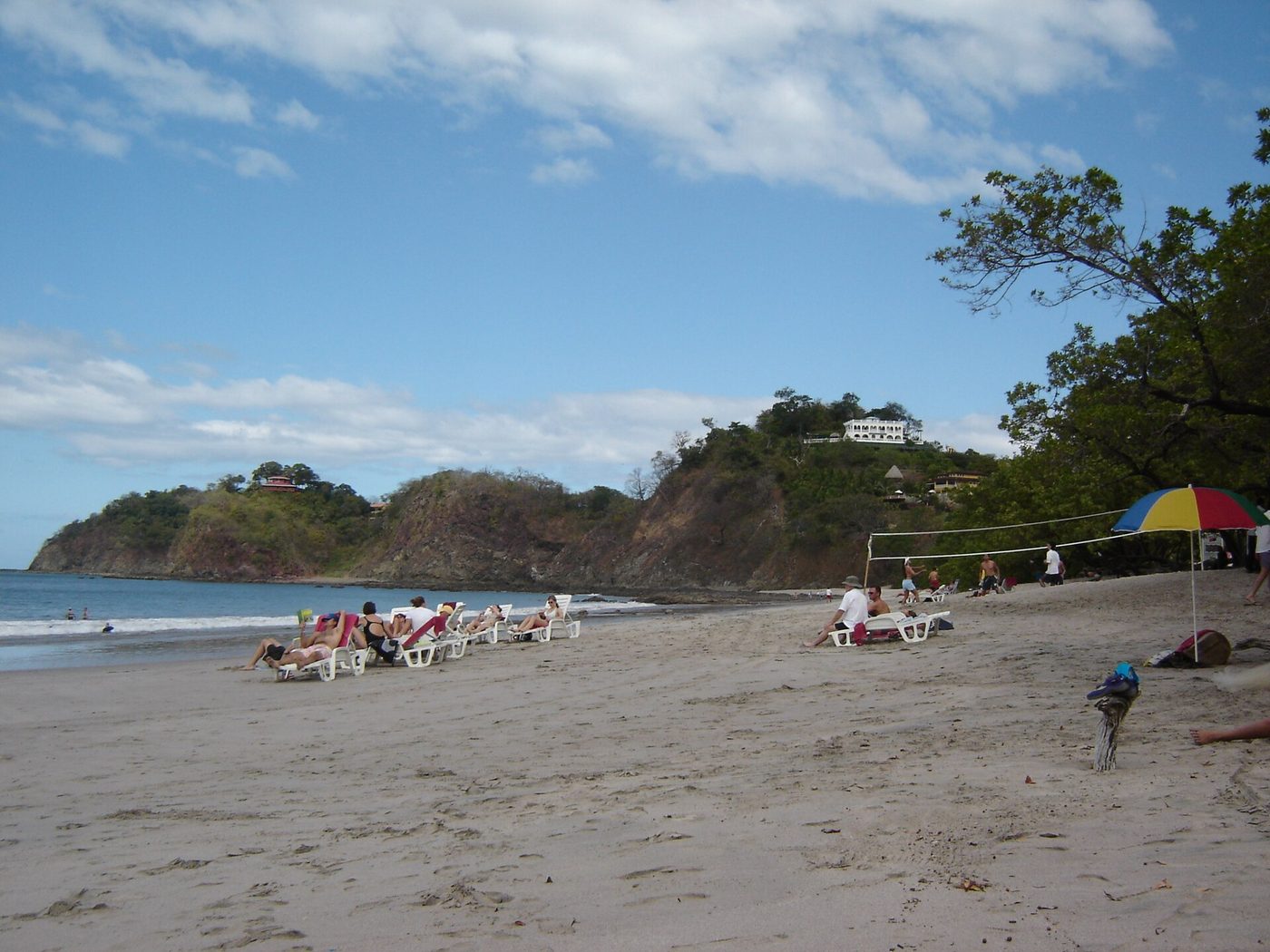 Sunbathers and beach umbrella on sunny Playa Flamingo, Guanacaste, in dry season