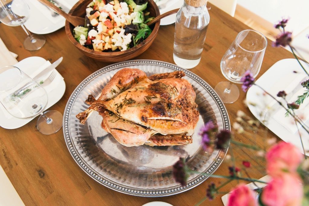 Roast turkey on a silver platter at a festive holiday dinner table