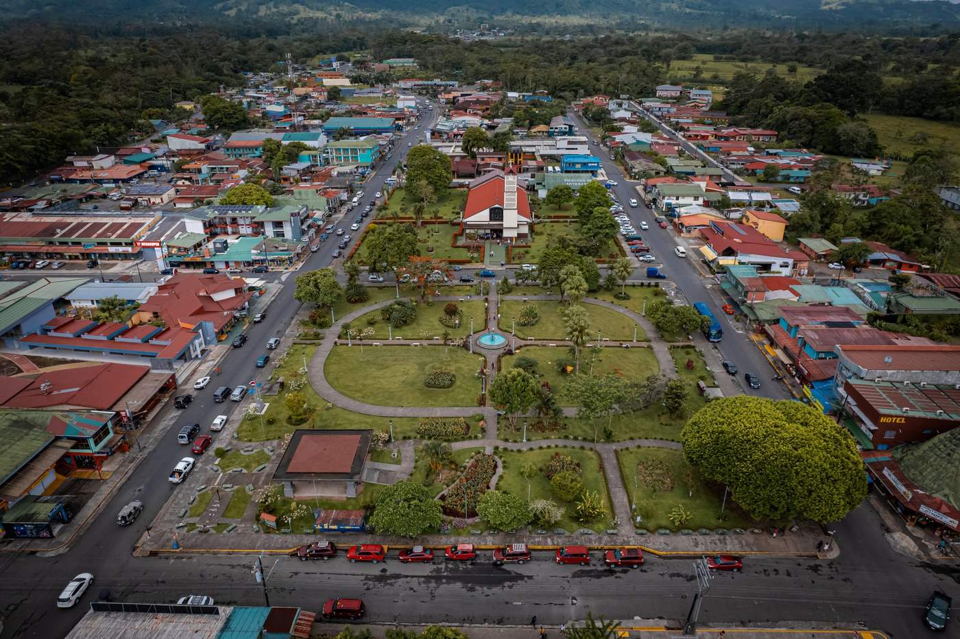 Aerial view of a small Costa Rican town with central park and busy streets