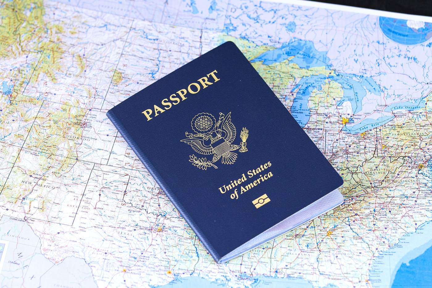 United States passport resting on a road map before a trip abroad