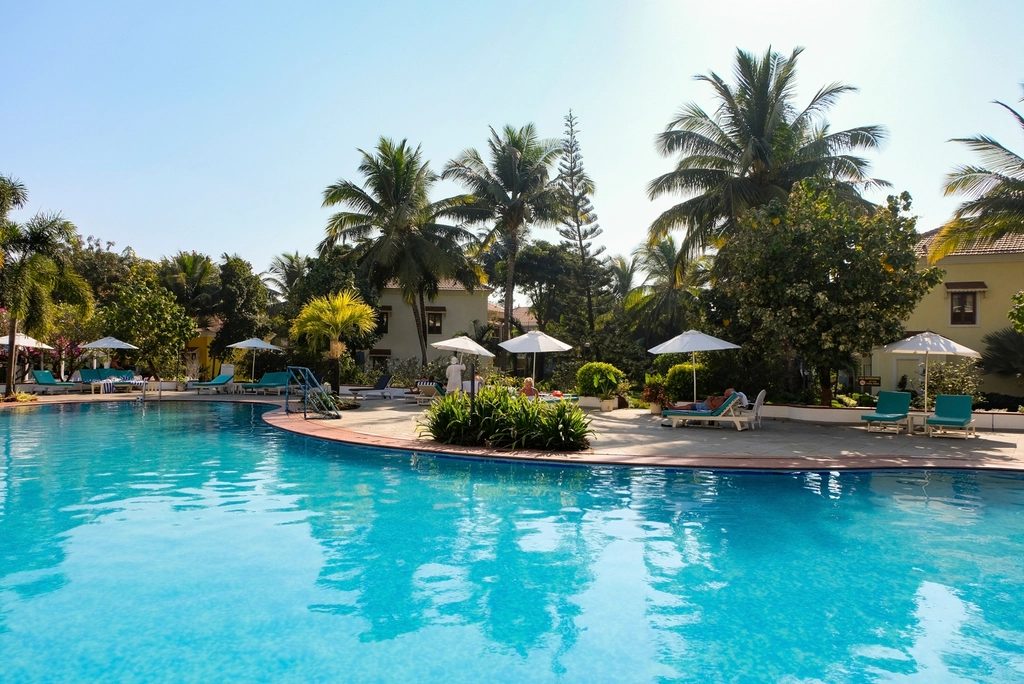 Turquoise pool and landscaped gardens at a low-rise tropical condo community