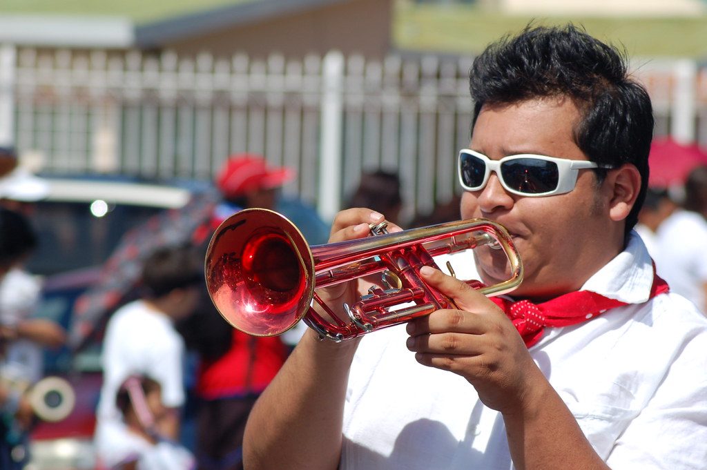 Band musician plays a red trumpet during a Costa Rica Independence Day parade