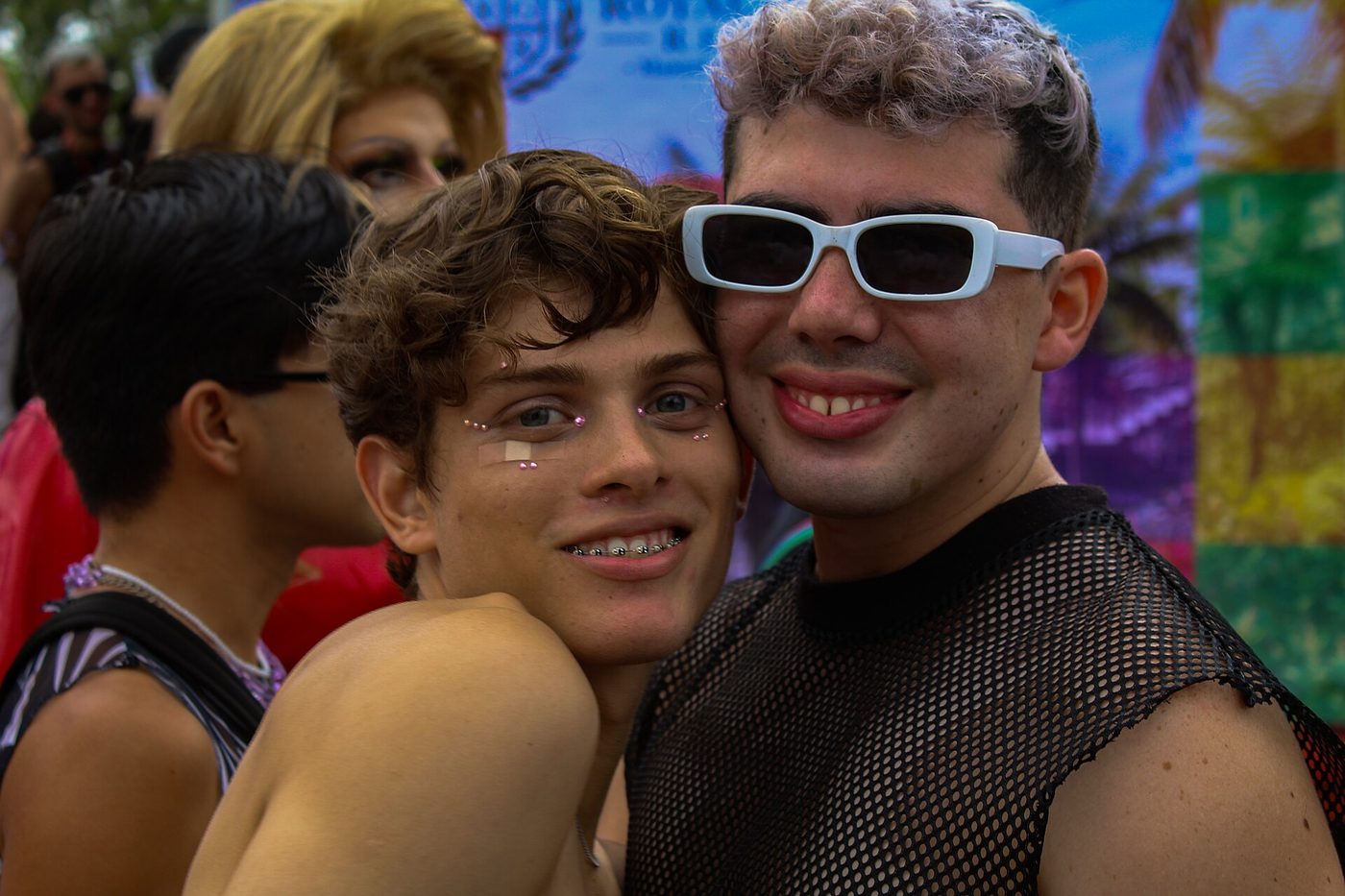 Two smiling young men pose together at the 2023 Pride march in Costa Rica