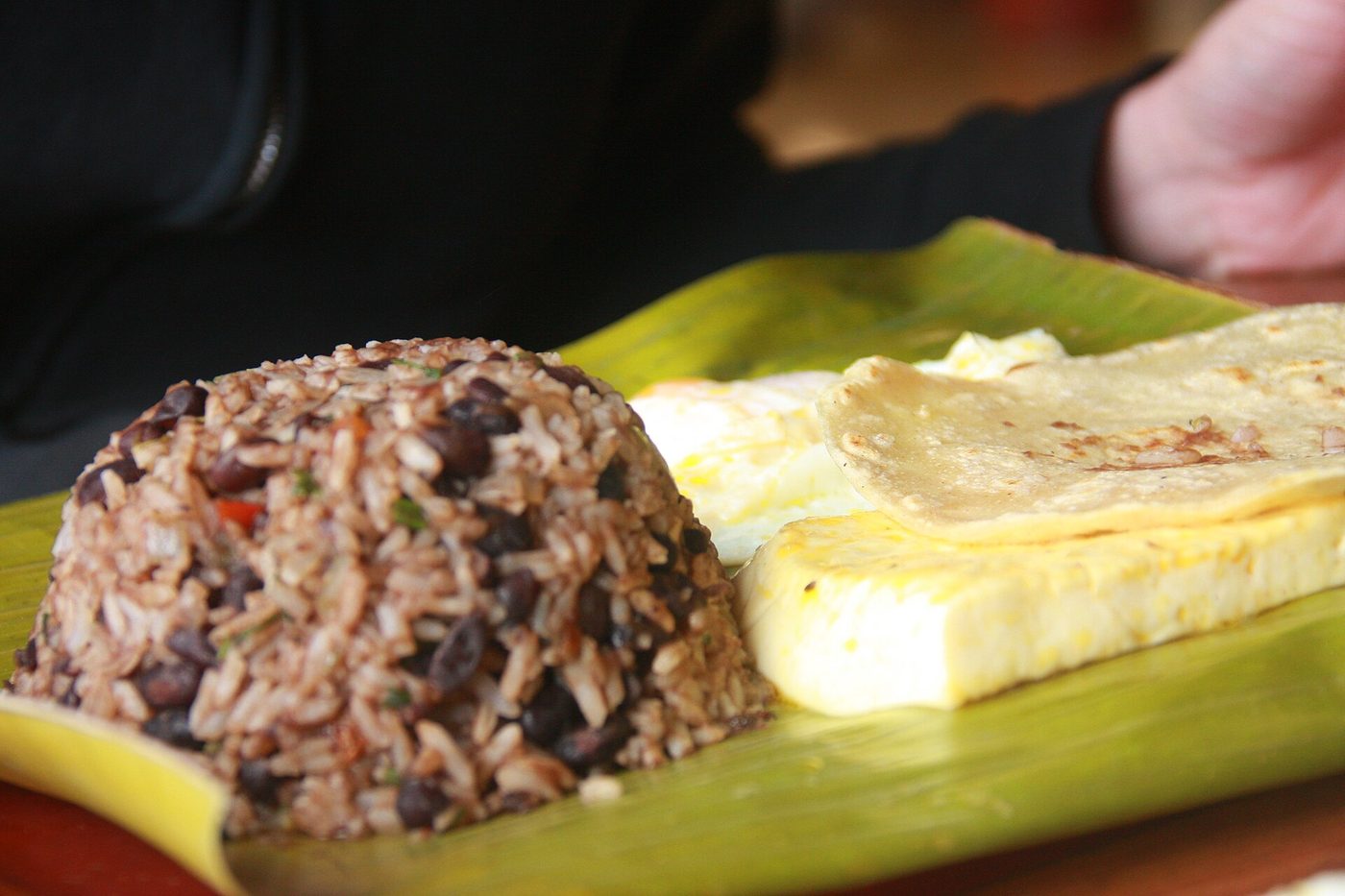Traditional Costa Rican gallo pinto breakfast with rice, beans, egg, and corn tortilla