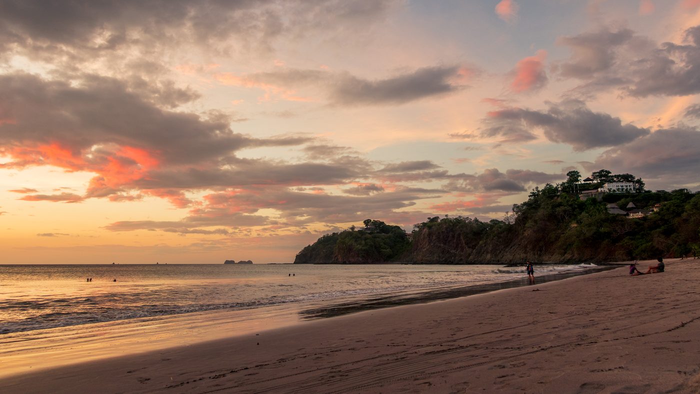 Sunset over Playa Flamingo beach with hillside homes above the Guanacaste coast