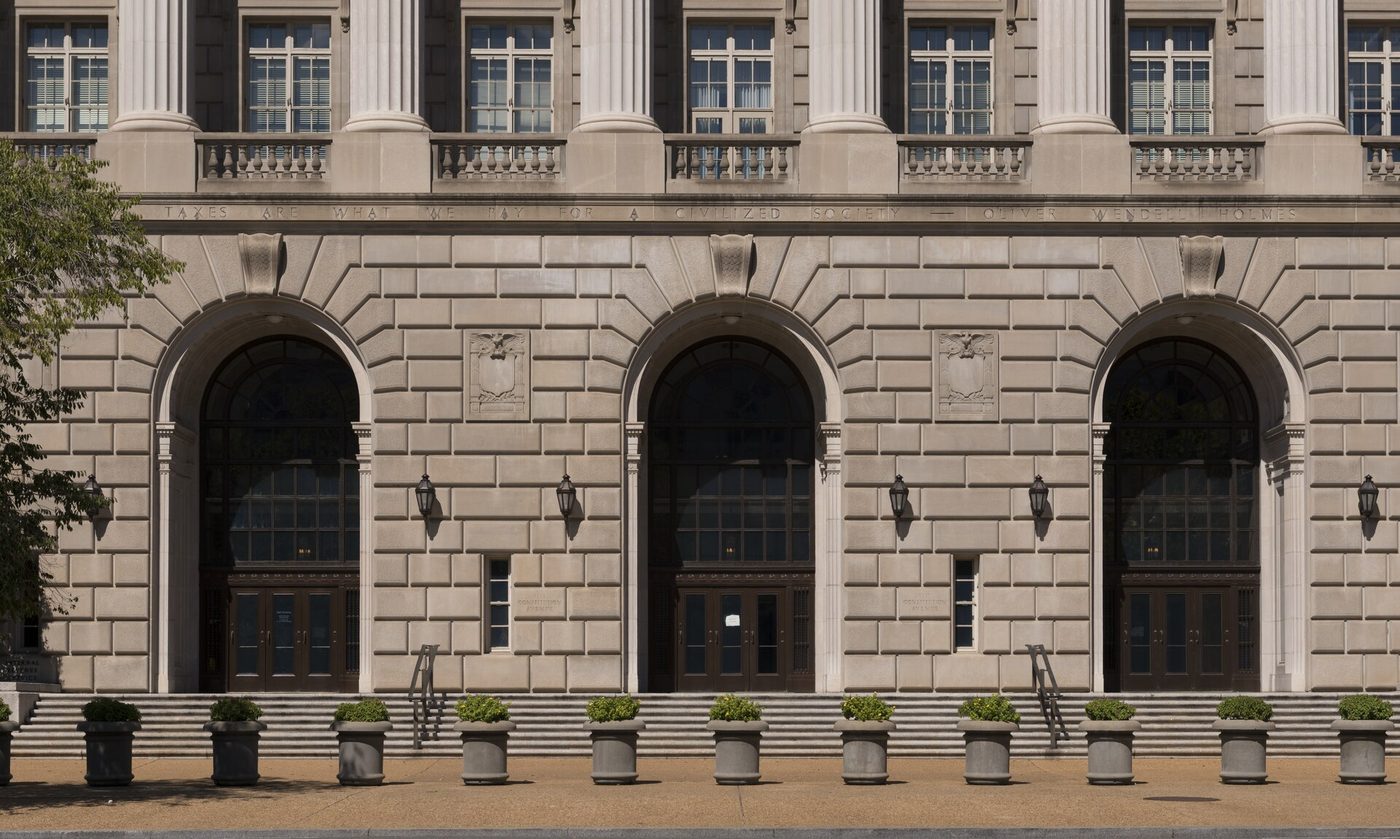 Entrance facade of the IRS headquarters building in Washington with carved tax inscription