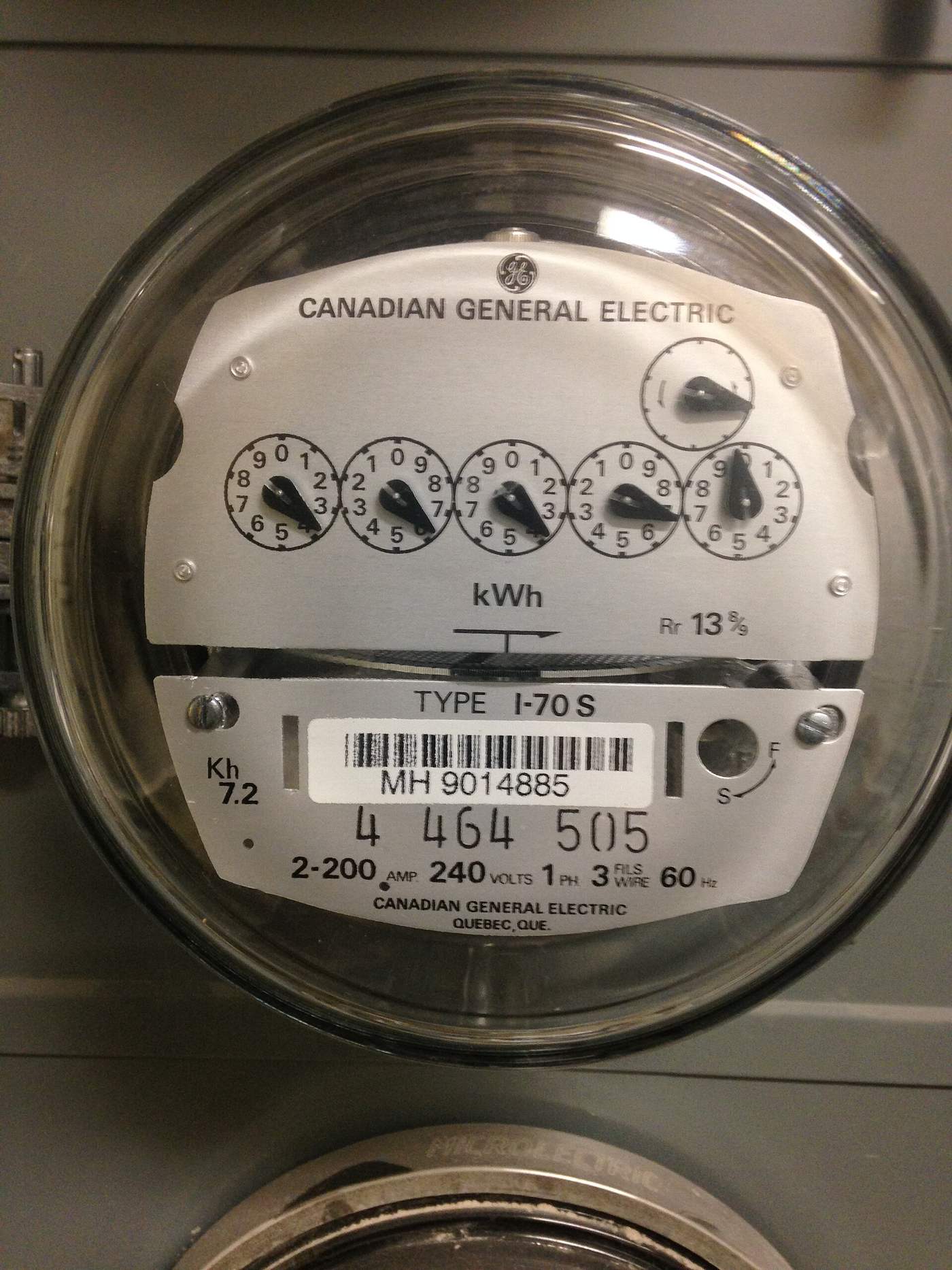 Analog residential electric meter in an apartment building tracking kilowatt hour use