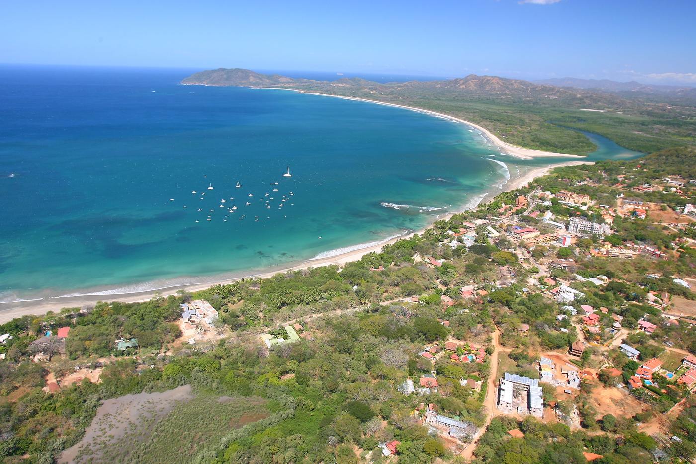 Aerial view of Tamarindo beach town and turquoise bay on Guanacaste's Gold Coast